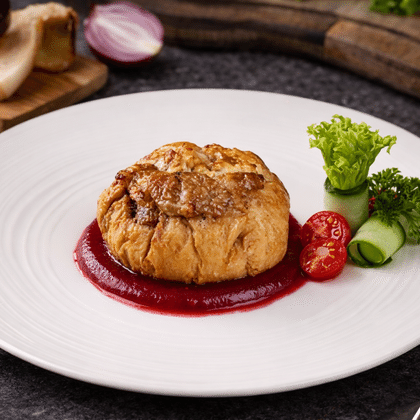 Свинина Уральская с белыми грибами под брусничным соусом